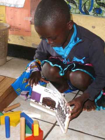 Children often match book themes to what they build, write, and draw. This girl made a train with colorful blocks, almost like the one in Freight Train. Integrated learning is prized in TEACH Rwanda schools.